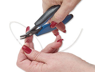 crimping pliers applying a crimp bead